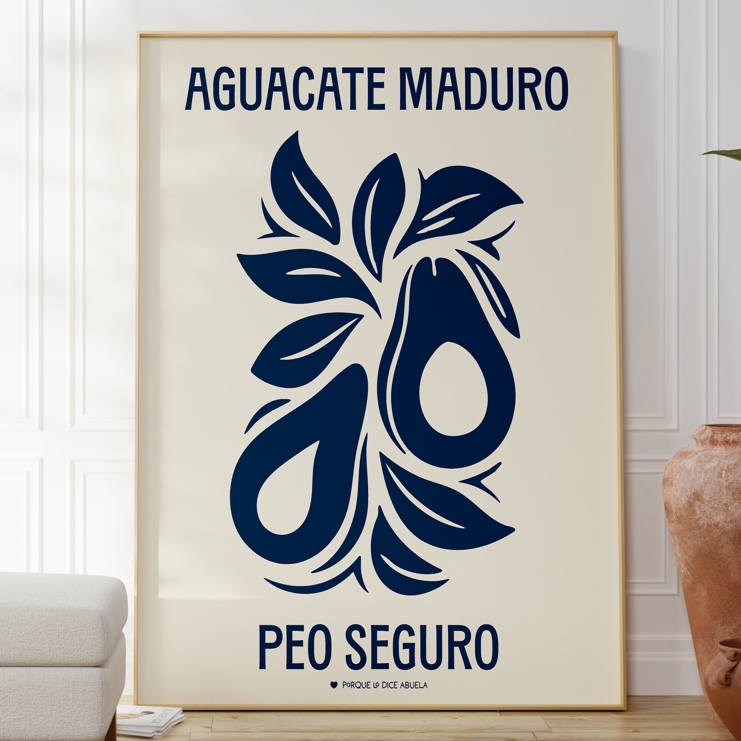 a framed poster with a blue and white design depicting two avocados and leaves. The poster has the text "Aguacate Maduro Peo Seguro" written on it.
