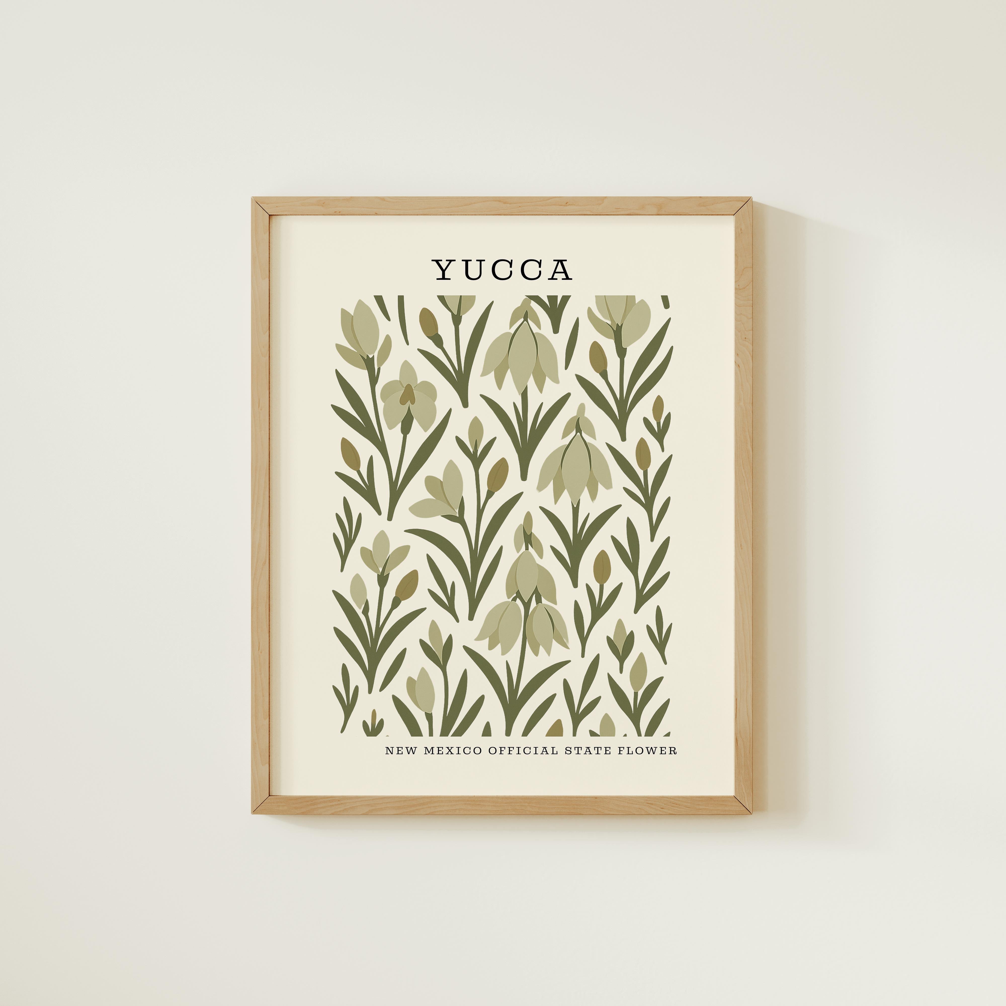 The image is a framed print featuring a repeating pattern of green leaves and flowers, with the text "YUCCA" prominently displayed.