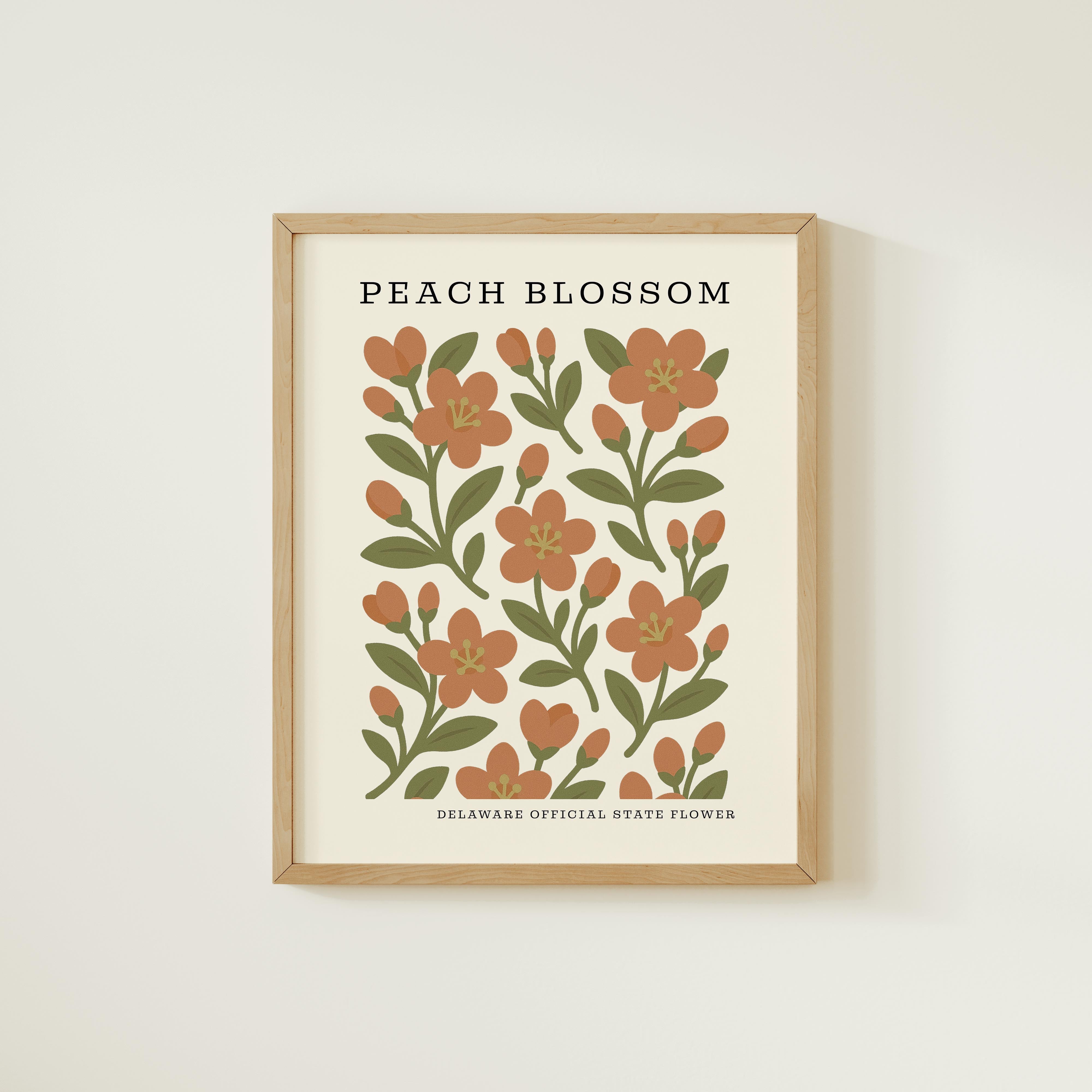 The image is a framed print featuring a repeating pattern of peach blossoms and green leaves, with the text "PEACH BLOSSOM" and "DELAWARE OFFICIAL STATE FLOWER" below the design.