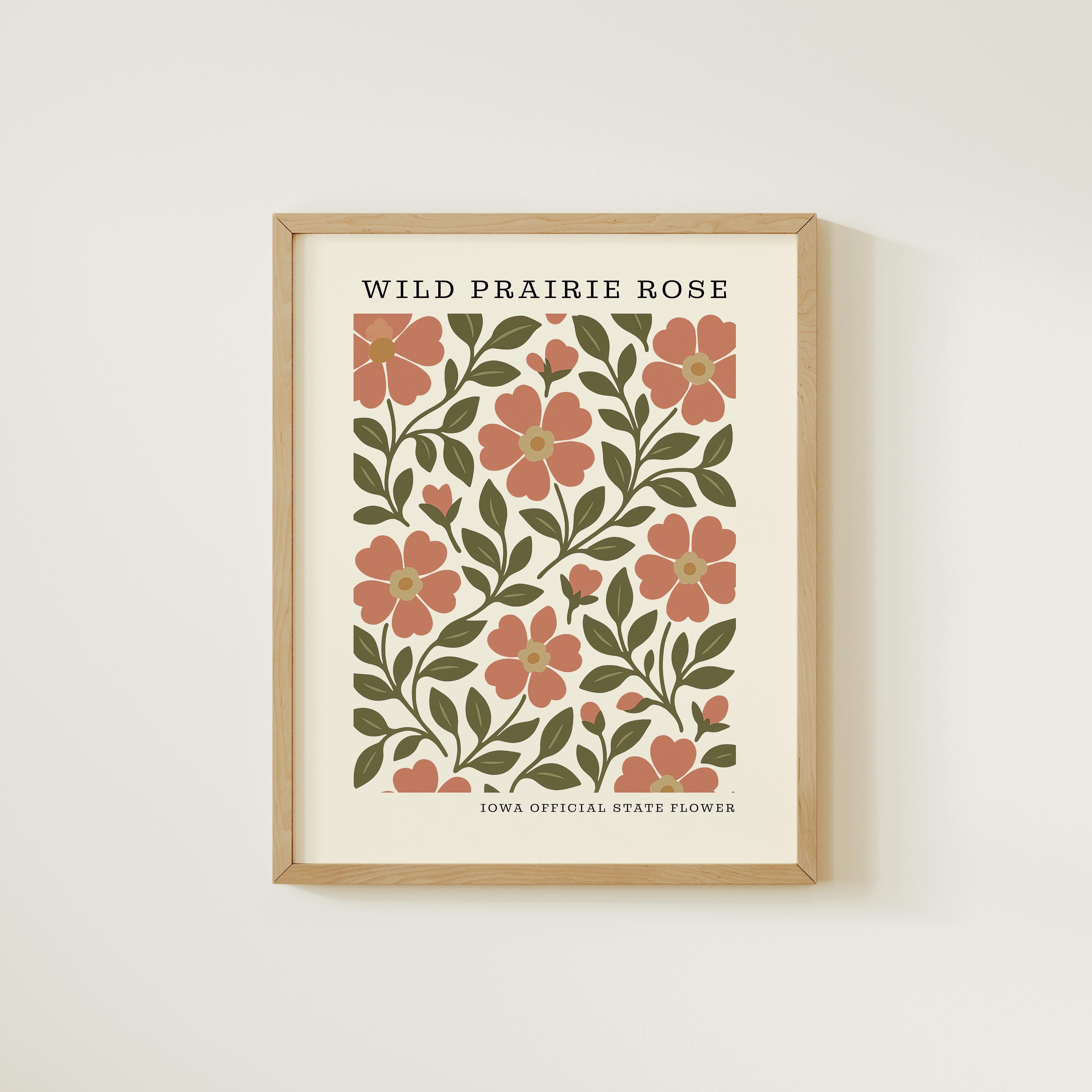The image is a framed print featuring a floral design with pink flowers and green leaves.