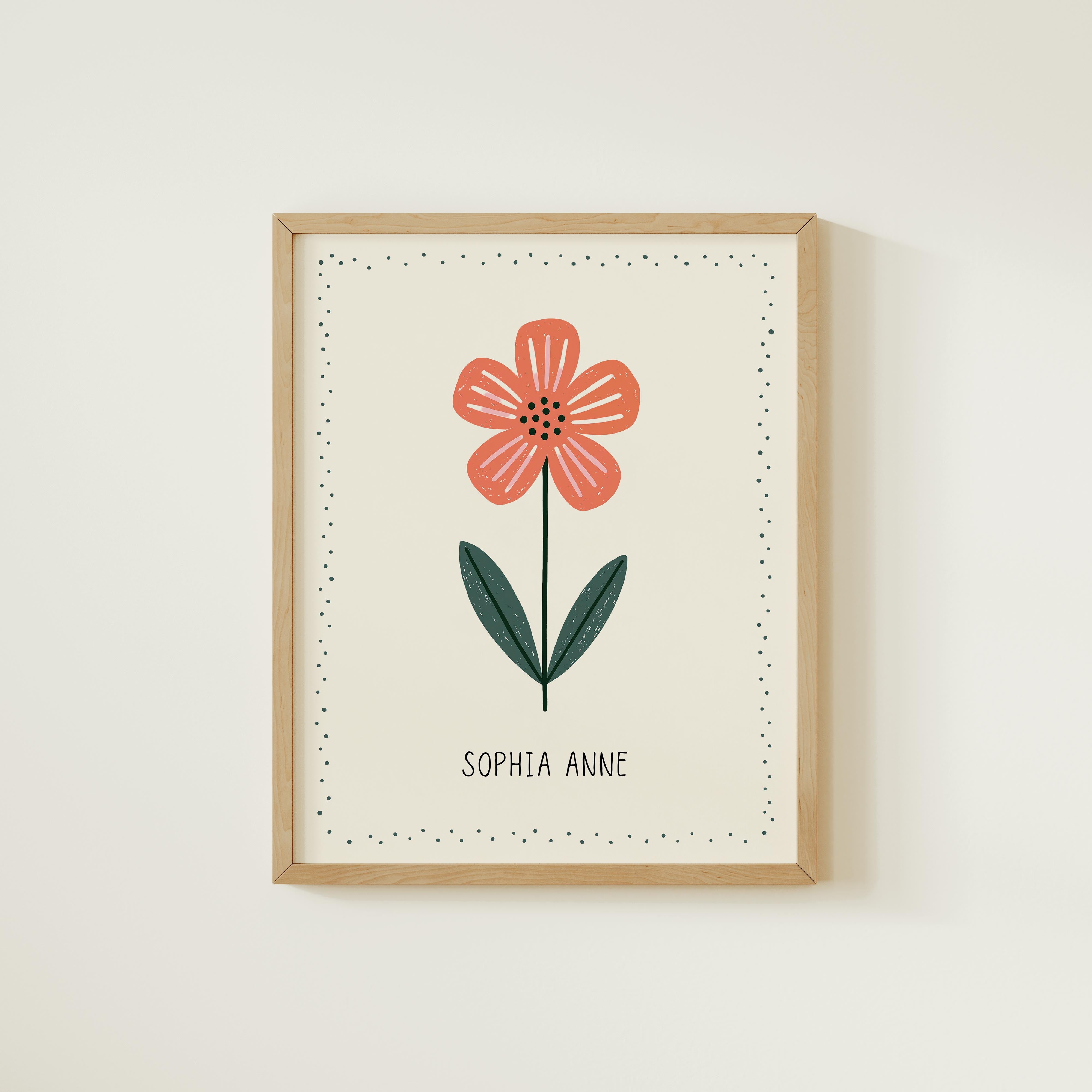 a framed print of a single red flower with green leaves, and the name "Sophia Anne" written below it.