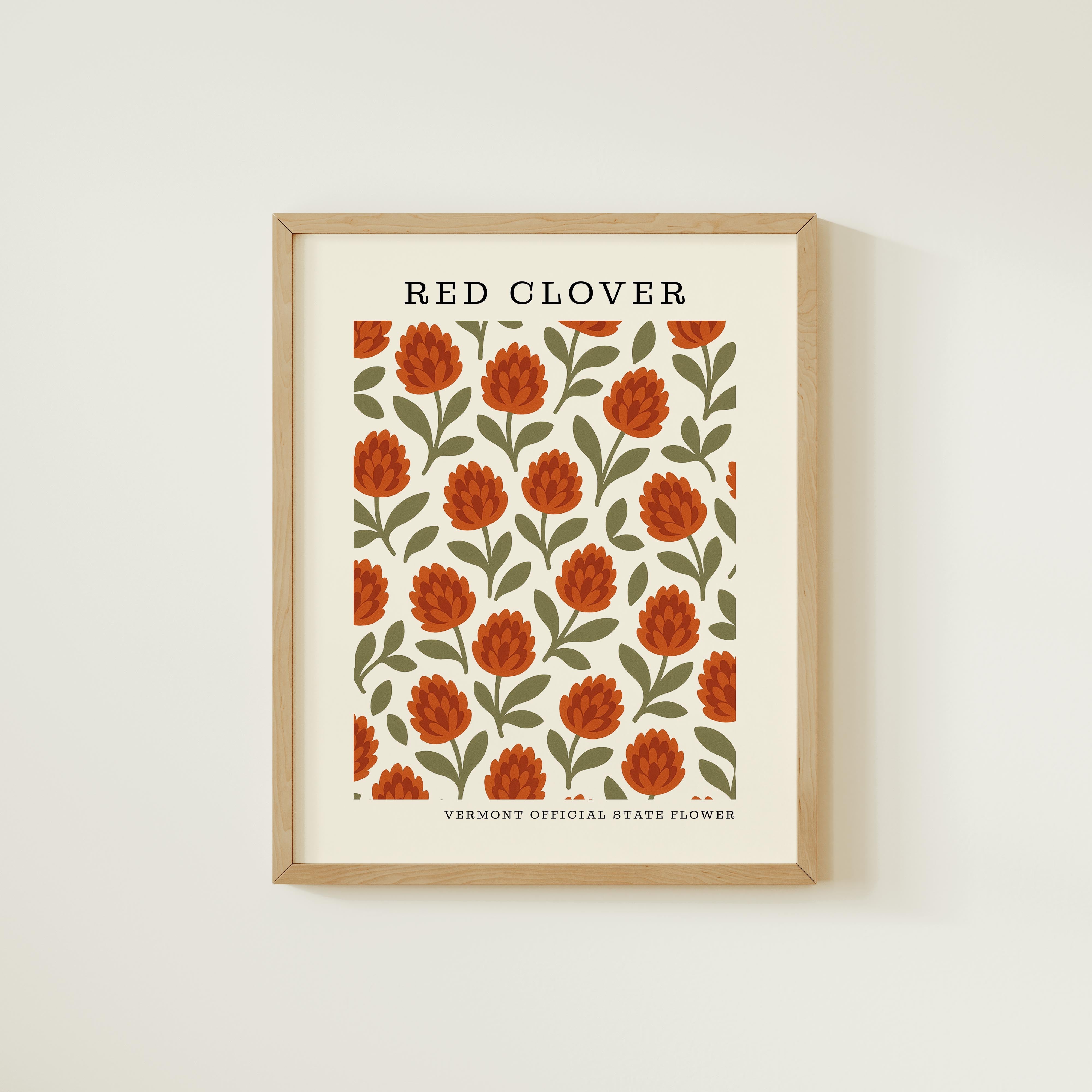 The image is a framed print featuring a repeating pattern of red flowers with green leaves, which appears to be a Vermont state flower.