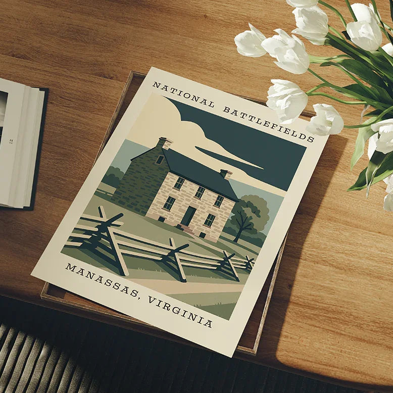 National Battlefields Manassas, Virginia poster on a wooden table with flowers and an open book.